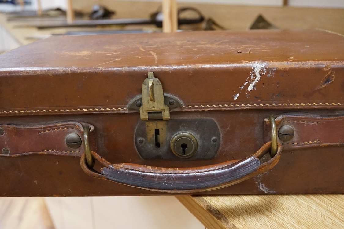 A Harrods brown leather gun/ammunition case, the lid with five leather restraining straps inside, and a good Harrods Ltd. Gun and Rifle Dept. label to the inside of the lid, dimensions; 40cm wide, 29cm high, 12.5cm deep